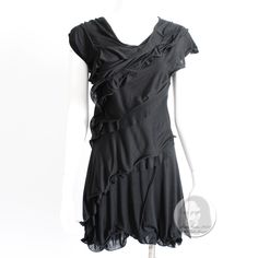 Authentic, Preowned Dress By Nina Ricci, Likely Made Around 2012. Made From Black Viscose, It Features Asymmetric Rows Of Loose Ruffles And A Low Cut Back. A Great Little Black Dress That's Easy To Wear And Style. Unlined; Has Straps At Inner Bodice To Secure Sleeves; No Fastener (Slips Over Head); 100% Viscose; Dry Clean Only. Tagged Size 34. Approximate Measurements (Taken Flat And Doubled Where Appropriate): Shoulders - 15in, Bust - 34in, Waist - 26in, Hips - 34in, Shoulder To Hem - 33in. Preowned With Signs Of Use And Prior Wear: We Note What Appears To Be Some Unprofessional Sewing Repairs Under The Wearer's Arms And At The Inside Bodice Shoulder Straps And A Small Pull Under On Black Asymmetrical Silk Dress, Black Asymmetrical Dress With Pre-draped Neckline, Pre-draped Asymmetrical Ruffle Dress, Black Asymmetrical Neckline Pre-draped Dress, Pre-draped Asymmetrical Dress With Ruffles, Black Pre-draped Asymmetrical Cocktail Dress, Black Asymmetrical Dress With Ruffle Hem, Black Dress With Asymmetrical Ruffle Hem, Black Dress With Ruffle Asymmetrical Hem