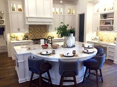 a large kitchen with white cabinets and an island