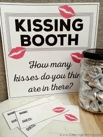 a sign that says kissing booth next to some candy in a glass jar with kisses on it