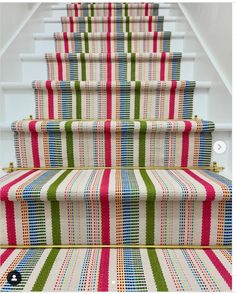 colorful striped carpeted stairs leading up to the second floor