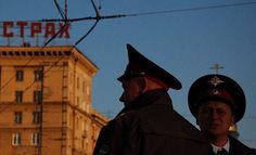 two police officers standing in front of a tall building