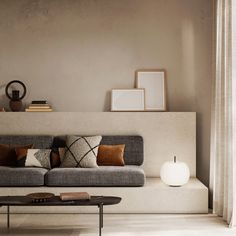 a living room with a couch, table and books on the shelf next to it