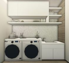 a small kitchen with two washers and a dryer