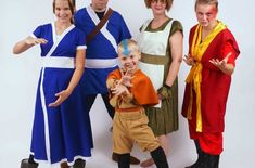 a group of people standing next to each other wearing costumes and posing for the camera