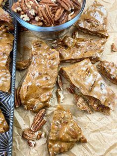 pecan brittles with caramel glaze and pecans in the bowl next to them