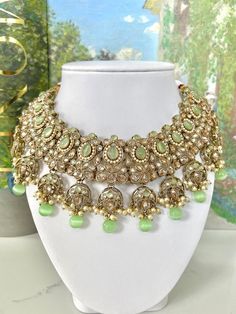 Sage Green Indian Jewelry, Antique Gold Necklace and Earrings | Punjabi Jewelry | Punjabi Jutti | Indian Jewelry | Sheeshphool | Matha Patti A stunning set in a beautiful unique colour - sage green. Wear this stunning Indian jewelry set to compliment your sage green outfit during a wedding this summer! Details: -Sage green necklace with adjustable gold cord -Sage green earrings -Sage green tikka -Pearl accents -Polki setting Shop more Indian jewelry sets here: https://www.etsy.com/shop/jazzyandco?section_id=23702907 *Please Note* Processing time will take 2-3 days once your order has been placed. Shipping time varies by location (5 days - 3 weeks). Please send me a message if you need your order urgently processed before this time. This item is non-refundable. FREE SHIPPING across Canada o Traditional Pista Green Jewelry For Wedding, Pista Green Jewelry For Festive Wedding, Traditional Pista Green Festive Jewelry, Traditional Festive Pista Green Jewelry, Green Tilla Jewelry Sets For Reception, Green Bollywood Sets With Intricate Design, Green Jewelry Sets For Reception And Festive Occasions, Antique Gold Necklace, Punjabi Jewelry