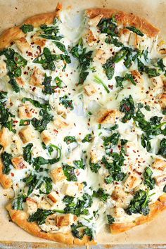 a pizza covered in cheese and spinach