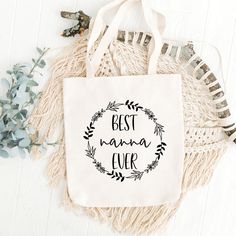 a canvas bag with the words best mama ever printed on it next to some flowers