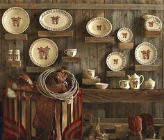 there are many plates and other items on the shelves in this room, including cowboy boots