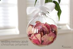 a glass ornament filled with pink and red flowers