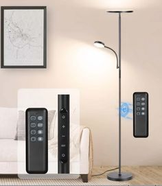 a living room with two remote controls on the floor next to a lamp and couch