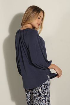 Product Details: Split neck top with self tie detail 3/4 length sleeves COLORS: navy Fit: true to size Unlined stretch Cupro fabric Fabric content: 70% MODAL, 30% POLYESTER Machine wash cold, tumble dry low. Follow care label, instructions may vary by fabric. Made in USA TF-2055 Length of top from HPS: xs/24.5” small 25” medium 26.5” large 27” x-large 27” Model height: 5 foot 8 inches Model is wearing a size S