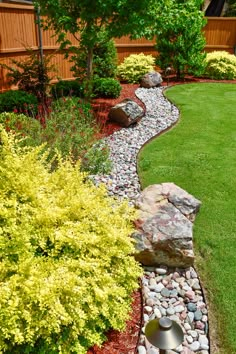 a garden with lots of rocks and grass