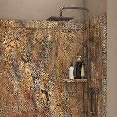 a bathroom with marbled walls and flooring, including a shower faucet