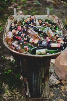 an old wheelbarrow filled with beer bottles