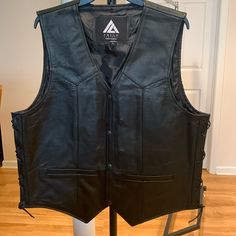 Nwot Arian Men Black Leather Motorcycle Vest/Casual Vest Sz. Large. Premium Quality Leather: Made From High-Quality, Genuine Leather That Is Soft, Supple, And Durable. It Offers Both Comfort And Longevity, Ensuring That It Will Withstand The Test Of Time. The Vest Is Adorned With Carefully Crafted Design Details Such As Intricate ... The Vest Features Functional Pockets, Providing You With Convenient Storage Options For Small Essentials Like Keys, Cards, Or A Smartphone. The Classic Leather Cons Classic Black Leather Vest, Fitted Leather Casual Vest, Casual Leather Vest, Casual Fitted Leather Vest, Black Casual Leather Vest, Casual Black Leather Vest, Safari Vest, Motorcycle Vest, Black Puffer Vest