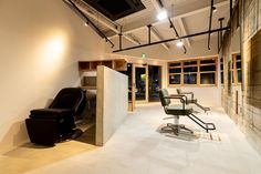 an empty room with chairs and lights on the ceiling