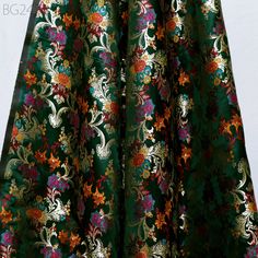 Bottle Green Brocade Fabric by the Yard Indian Banarasi Wedding Dress Material Historic Costume Banaras Knee Length Coat Sewing Upholstery Drapery. This is a beautiful multi color banarasi pure silk brocade in floral design fabric in multi color (Bottle Green with Yellow, Magenta, Red, Turquoise, Sea Green) and Gold. ➤Product: Brocade Fabric ➤Fabric Type: Blended Silk (Viscose + Rayon and 30% Silk) Fine Quality Zari Brocade Weaving from Banaras ➤Color: Base color is Bottle Green with Yellow, Magenta, Red, Turquoise, Sea Green and Gold. ➤Width: 42 Inches ➤Condition: New  ➤Code: bg2467 ➤Listing for 1 Yard of fabric. ➤Care: Dry Clean Only Super Fine Quality Brocade Weaving from Banaras. During the Mughal period (1556-1707), when brocade was extremely popular with the rich, the great center of Brocade Fabric With Intricate Embroidery, Floral Embroidered Jacquard Fabric For Wedding, Brocade Fabric With Floral Embroidery For Wedding, Green Brocade Fabric, Sewing Upholstery, Wedding Dress Material, Coat Sewing, Knee Length Coat, Red Turquoise