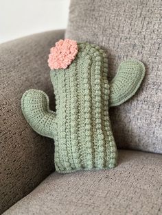 a crocheted cactus sitting on top of a couch