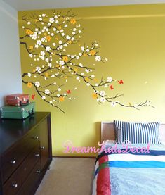 a bed room with a neatly made bed and a painting on the wall