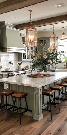 a large kitchen with an island in the middle and lots of stools around it