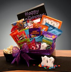 Send some Halloween goodies to your favorite Trick or Treater with this Candy Crush Gift Box. It is packed with a spell-binding selection of favorite candies. Do you know a little goblin that has a big crush on candy? This delicious Halloween Gift box is the perfect gift for all those teenagers on your list who think they're too old to trick or treat anymore. It's a wonderful and thoughtful college student gift or a loved one far away, and they're all sure to gobble this gift right up!  The Halloween Candy Crush Care Package includes: Ghost marshmallow peeps, movie butter microwave popcorn, cracker jacks, Twizzlers, Milk chocolate M&M's, Peanut Butter M&M's, Halloween pretzels, Halloween cheese puffs, Chex Mix, Trolli gummy worms, Marshmallow eyeballs, Zombie gummy boogers, Zombie sour pun Planner Gift Basket, Halloween Pretzels, Halloween Gift Baskets, Best Gift Baskets, Marshmallow Peeps, Kids Gift Baskets, Candy Basket, Halloween Bows, Halloween Goodies