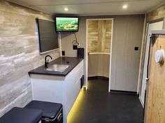 a small kitchen area with a sink and television