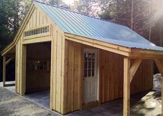 a wooden garage with a metal roof