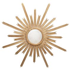 a sun shaped mirror hanging on the wall