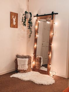 a room with a mirror, rug and lights on the wall next to a bed