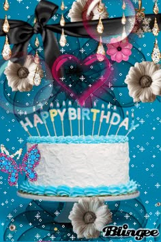 a birthday cake decorated with flowers and a heart on it's top is shown