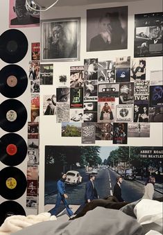 a bedroom with records and pictures on the wall