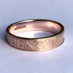 "This beautiful ring has been cast from a hand carved original design, in the mediaeval minuscule script and features the Latin inscription Alis Volat Propriis which translates as 'she flies with her own wings'. A motivational motto ring reflecting a sense of self worth, self-love, the ring has been cast from a hand- carved master made by Ford Hallam, the world's leading Japanese Metal Artist. Good for a special birthday or a best friend gift, perhaps a personal present after a divorce or break Symbolic Rose Gold Promise Rings, Symbolic Etched Yellow Gold Rings, Adjustable Engraved Rose Gold Ring Stamped 14k, Rose Gold Engraved Ring, Hallmarked, Hallmarked Engraved Rose Gold Ring, Rose Gold Engraved Ring With Hallmark, Heirloom Rose Gold Rings With Hallmarks, Symbolic Yellow Gold Rings With Hallmarks, Yellow Gold Promise Rings With Hallmarks