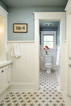 a bathroom with blue walls and white fixtures