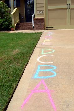 the sidewalk has been painted with chalk and is in front of a garage door that says,