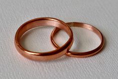 This copper wedding ring set is a casual but beautiful set of rings for the person looking for an affordable option for that special day.    Each band is made of pure 99.9%  copper, handmade at time of purchase.   Personalize your bands with a date or words on the inside of band.  choose your personalization at checkout.  SIZE The men's ring band is 14 gauge copper wire women's band is 16 gauge copper wire PROCESSING TIME This ring will take 1-3 business days to create and ready to ship.  SHIPPI Handmade Rose Gold Stackable Rings For Wedding, Elegant Rose Gold Copper Rings, Adjustable Copper Wedding Rings, Adjustable Copper Rings For Wedding, Rose Gold Copper Ring For Anniversary, Gold Copper Ring For Wedding, Gold Copper Wedding Ring, Copper Wedding Rings, Copper Wedding Band