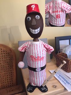 a paper mache baseball player is posed on a table