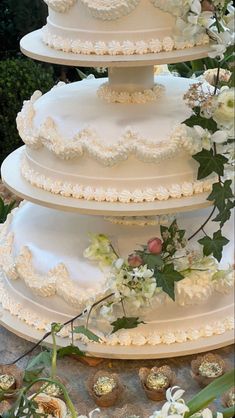 three tiered wedding cake with white flowers on top