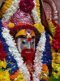 an idol is adorned with flowers and garlands