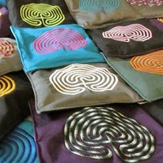 many different colored pillows with designs on them