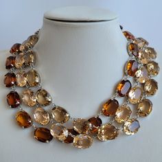 These Anna Wintour style statement necklaces are made with beautiful transparent oval crystals,  dimension 13x18 mm in beautiful Smoky Topaz, Light Colorado Topaz and Light Peach color. The crystals are accentuated beautifully with the silver setting. You can wear them separately or layer them all together for full impact,  sure to get compliments and attention. Their versatility makes them perfect for parties and other celebratory gatherings. Quality of the stones and settings makes them a perfect candidate for becoming heirloom pieces. It is elegant, classy and very "Anna Wintour style". Crystals - 13x18 mm Oval point back strass. Crystal Colour - Smoky Topaz. Necklace setting - Silver plated Brass (nickel, cadmium and lead free). Necklace length - Measures 16 inches, it also has 1,5 inc Formal Oval Crystal Necklaces, Formal Oval Crystal Necklace, Oval Crystal Necklaces For Parties, Anna Wintour Style, Necklace Gold Jewelry, Statement Necklace Gold, Light Peach Color, Smoky Topaz, Necklace Swarovski