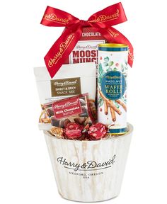 a gift basket filled with chocolates, nuts and other items for christmas or any special occasion