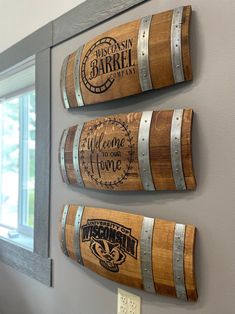 three wooden barrels are hanging on the wall