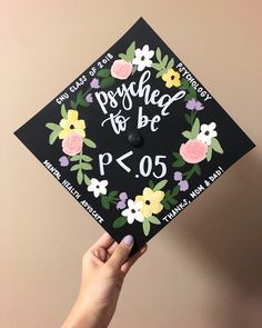 a person holding up a graduation cap with flowers on it that says, proud to be pf05