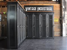 the inside of an industrial storage room with metal lockers and signs on the walls