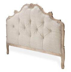 the headboard is upholstered with an old - fashioned style frame and buttons