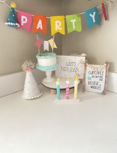 a birthday party with cake, candles and decorations