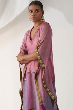 Pink kaftan with antique dot embellished on velvet, outlined all-over on the color blocked base with horizontal gota and ghunghroo detailing. Comes with a padded bralette and a skirt.
Components: 3
Pattern: Embellished
Type Of Work: Gota and Ghunghroo Work
Neckline: Plunged V
Sleeve Type: Batwing
Fabric: Tissue
Color: Pink
Other Details: 
Padded bralette
Velvet bordered kaftan
Elasticated skirt waistband
Approx. product weight (in kgs): 2-3
Length:
Kaftan: 50 inches
Skirt: 36 inches
Occasion: Me Elasticated Skirt, Pink Kaftan, Kaftan Set, Skirt Waistband, Blouse Yoke, Padded Bralette, Indian Ethnic Wear, Bat Wings, Designer Wear