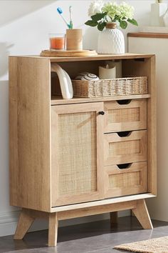 a wooden cabinet with baskets on top of it