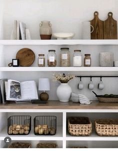 the shelves are filled with different types of items in baskets and jars on top of them